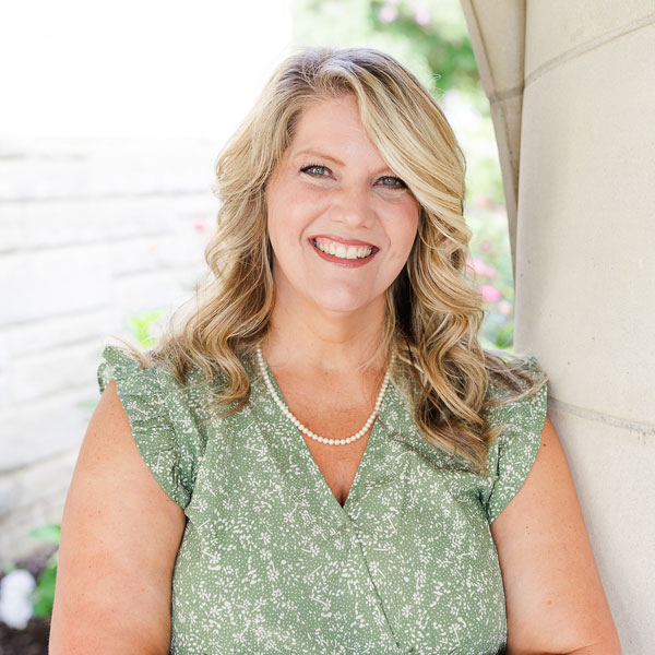 Carrie, Patient Relations Specialist at Clarity Eye and Face, is depicted with blonde hair and a green shirt